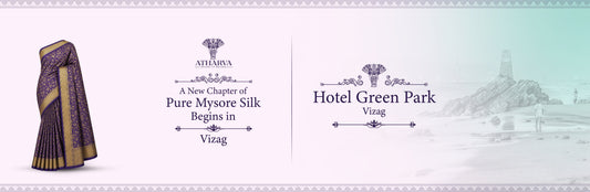 Promotional banner for Atharva House of Sarees announcing the Pure Mysore Silk Expo at Hotel Green Park, Vizag, featuring a purple Mysore silk saree and the scenic RK Beach memorial backdrop.