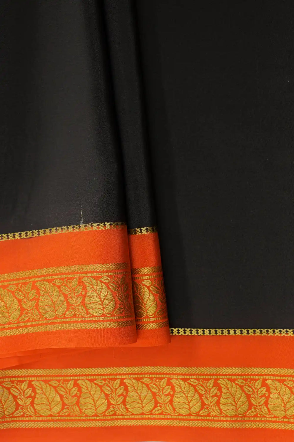 Black Mysore silk saree with orange pallu and gold zari border