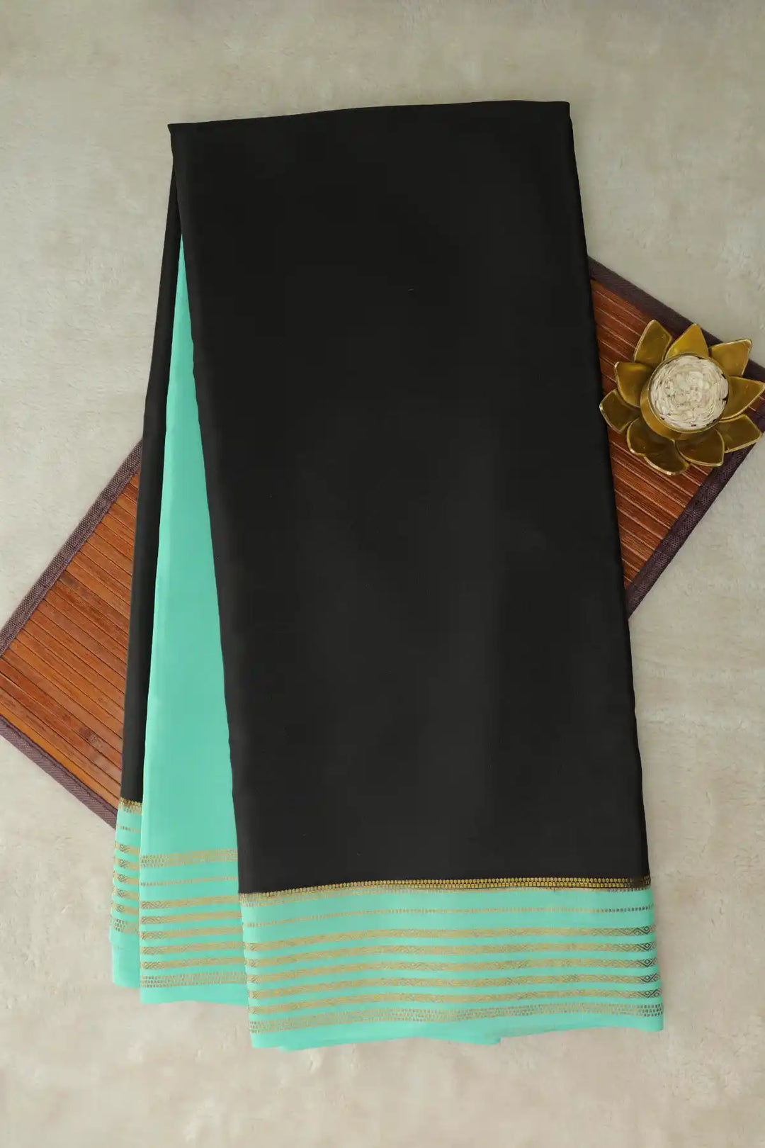 Black silk saree with green border and decorative pallu