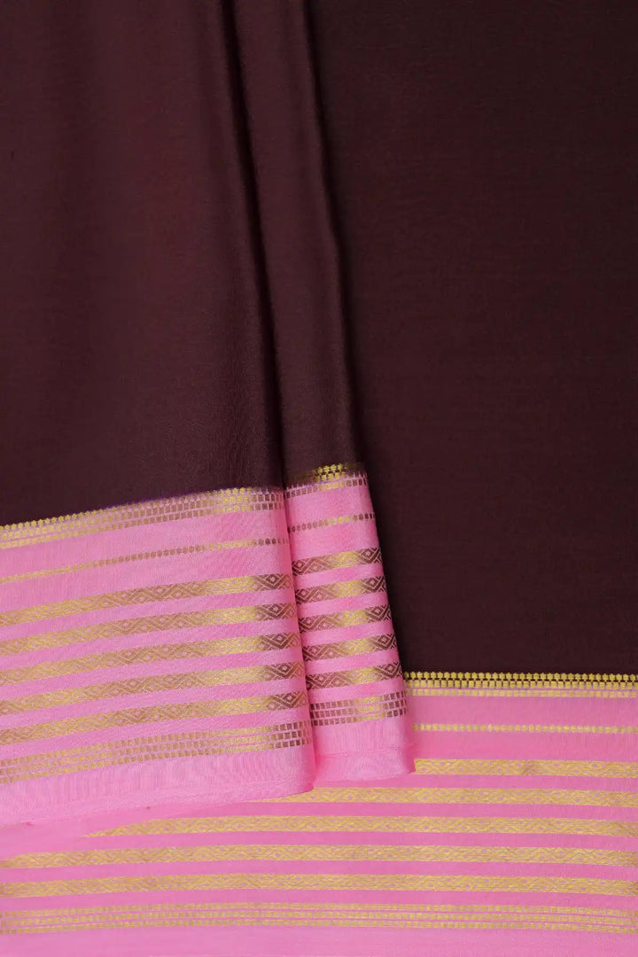 Brown saree with pink border and golden stripes