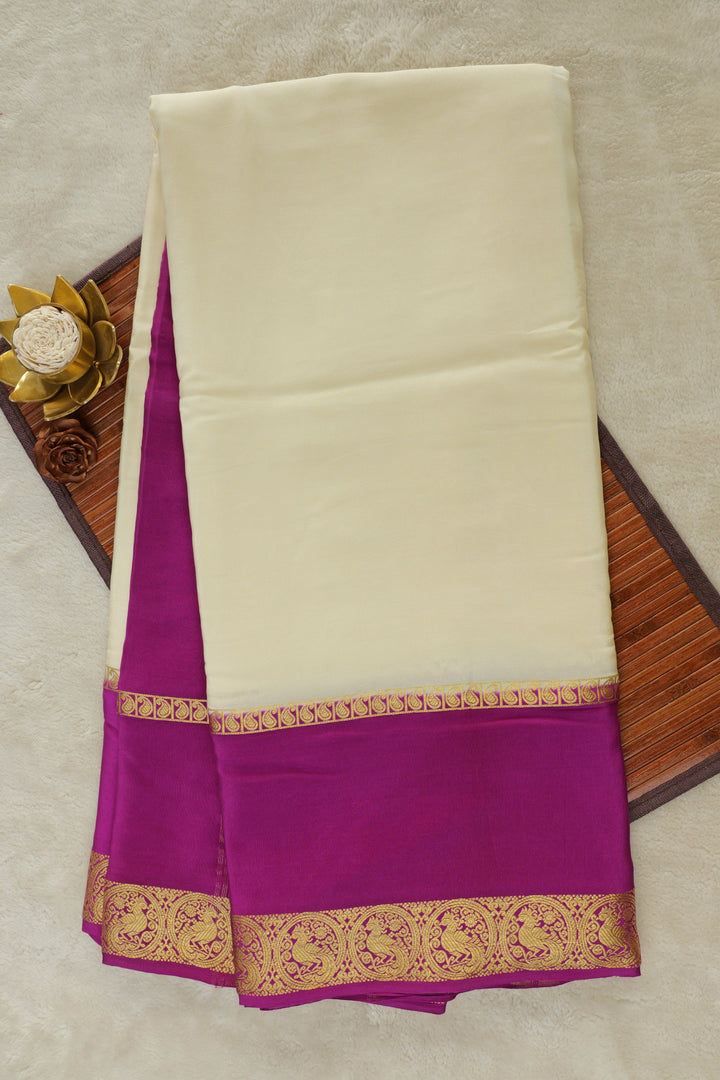 Cream Mysore silk saree with purple contrast border and golden zari work