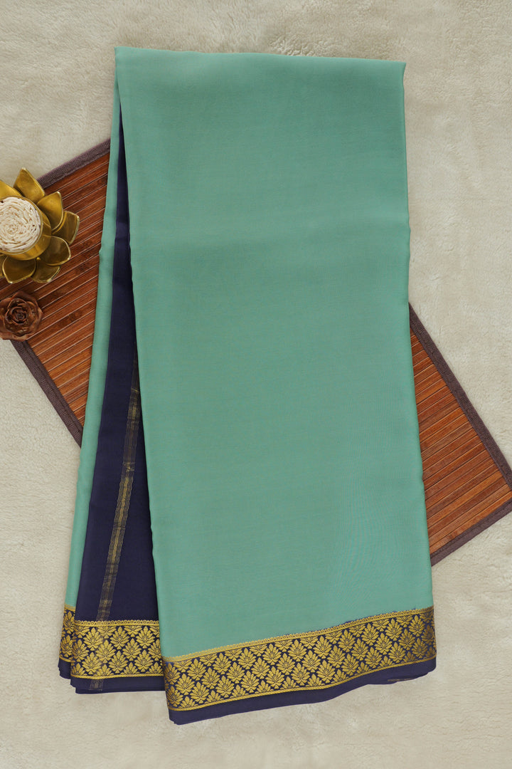 Green Mysore silk saree with navy blue border and golden zari design