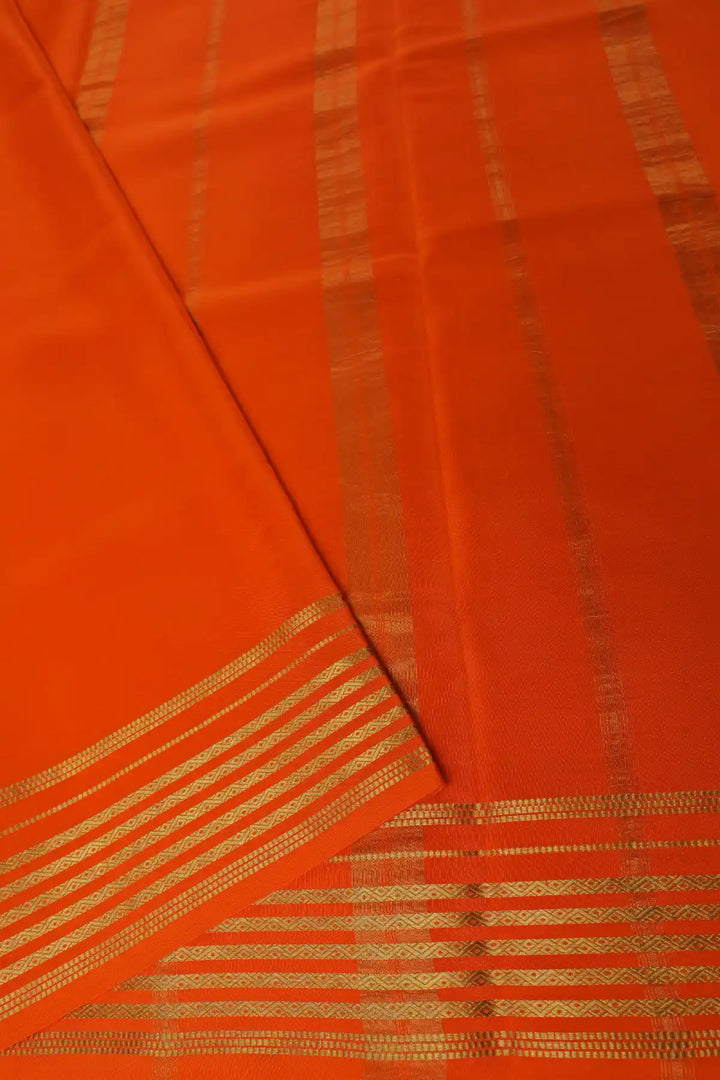 Green saree with orange striped border and blouse