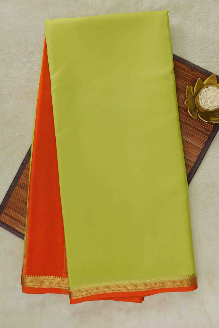 Light green Mysore Silk Saree with an orange pallu and gold border