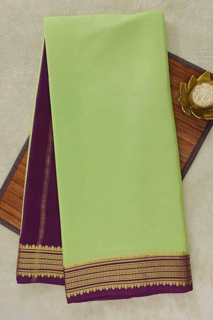 Mysore Silk Saree in green with a purple pallu and golden woven border