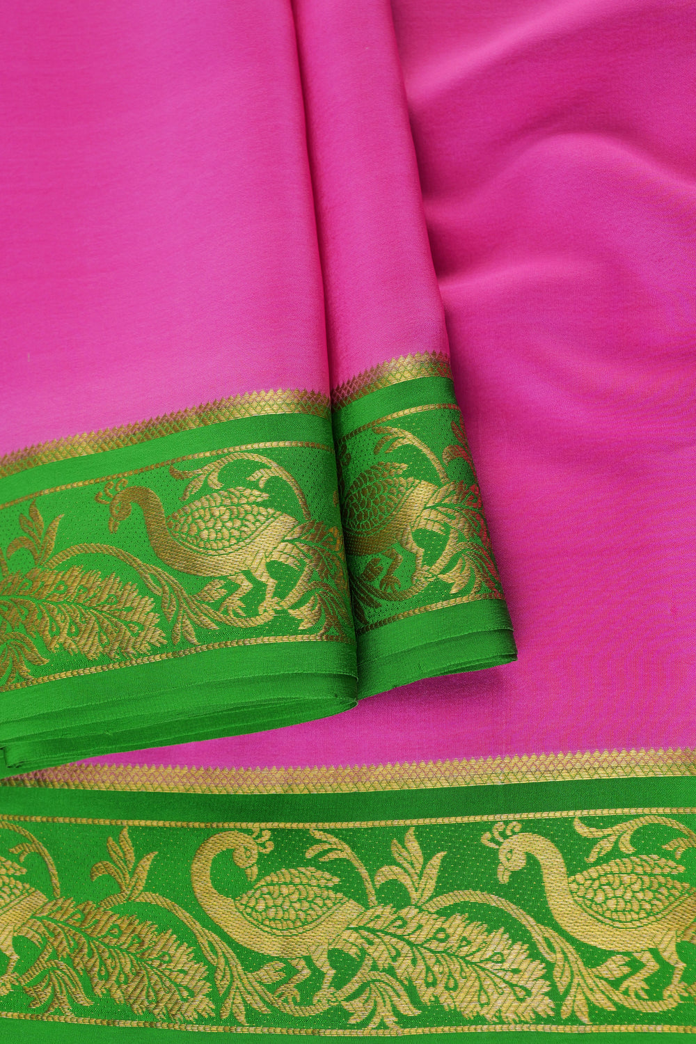 Mysore crepe silk saree featuring a vibrant pink body and rich green zari border