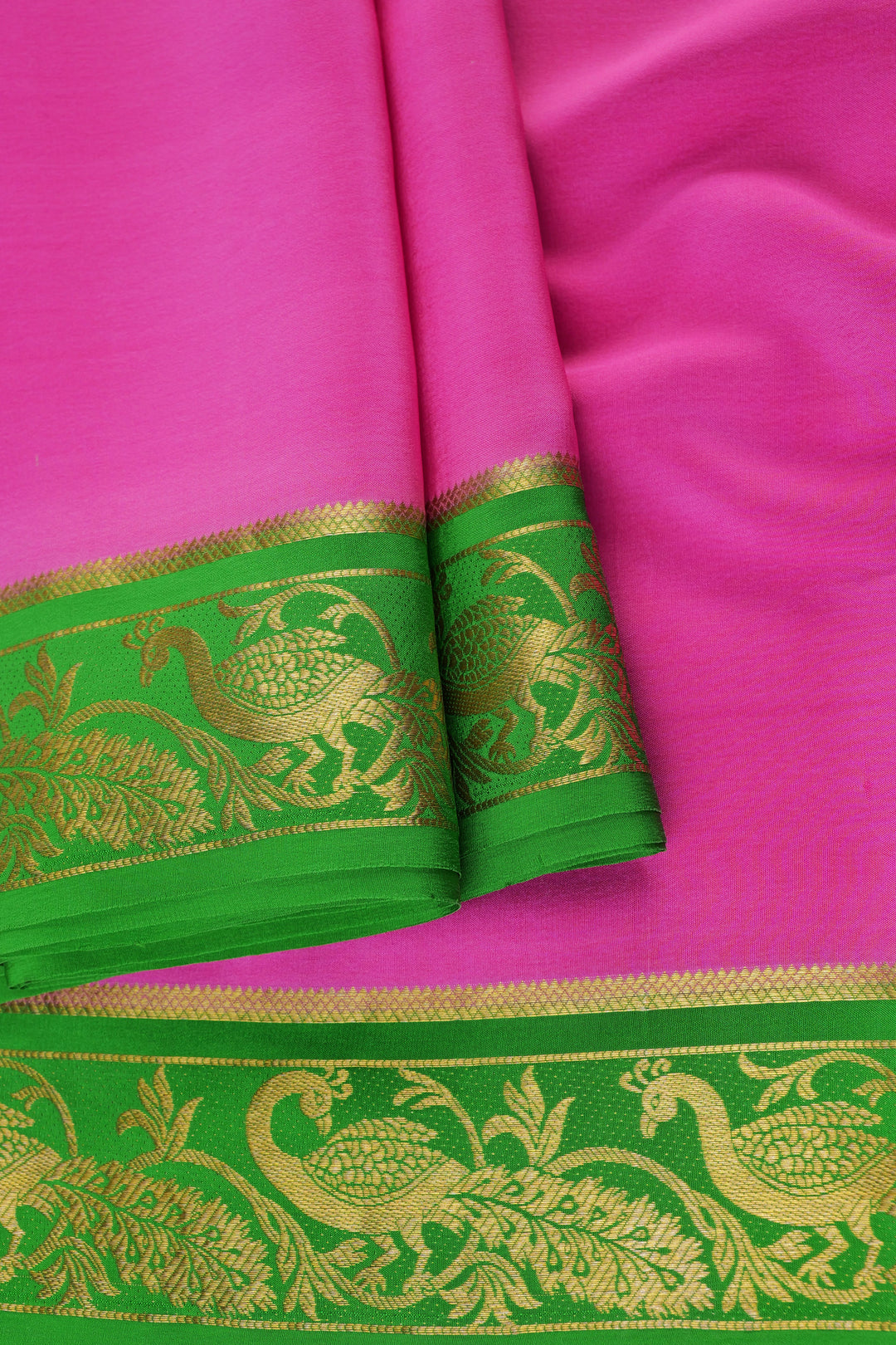 Mysore crepe silk saree featuring a vibrant pink body and rich green zari border