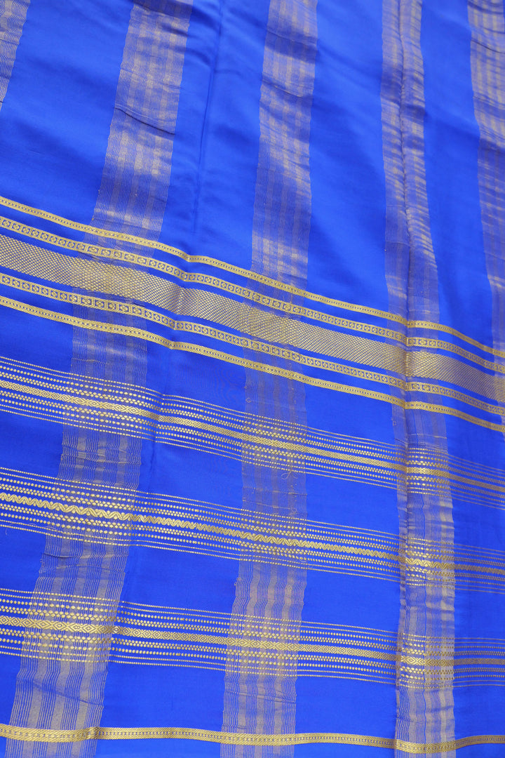 Mysore silk saree in deep blue with golden stripes on the pallu and zari border