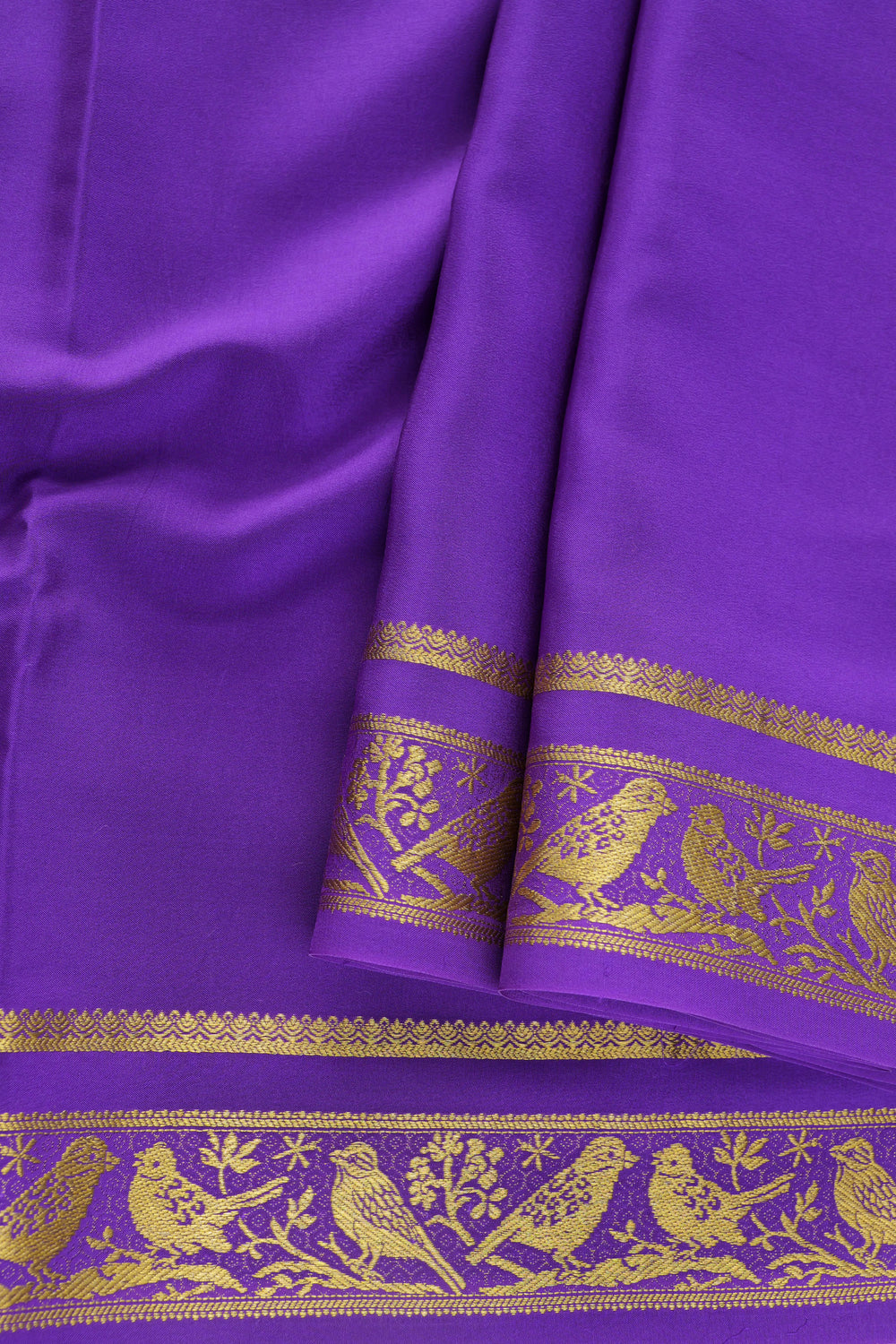 Mysore silk saree in deep purple color adorned with gold motifs
