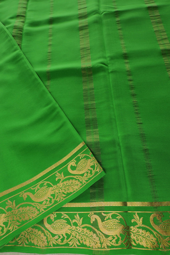 Mysore silk saree in pink with green pallu and golden peacock border design
