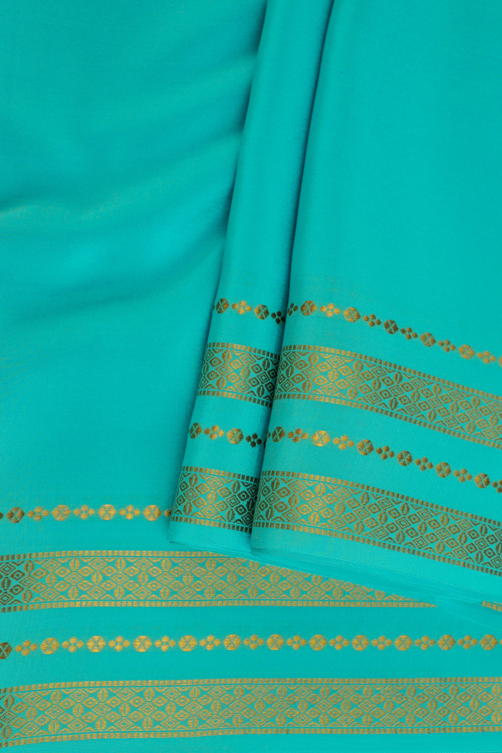 Mysore silk saree in turquoise blue featuring a shimmering golden border