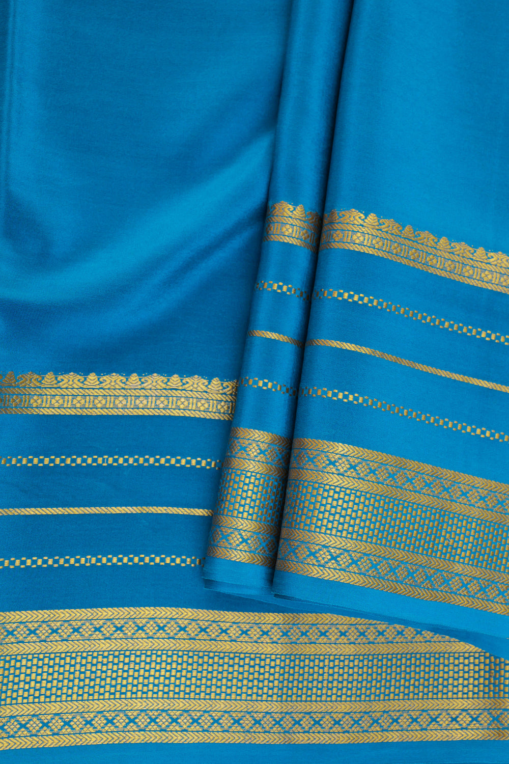 Mysore silk saree with a blue body and a woven gold zari border.