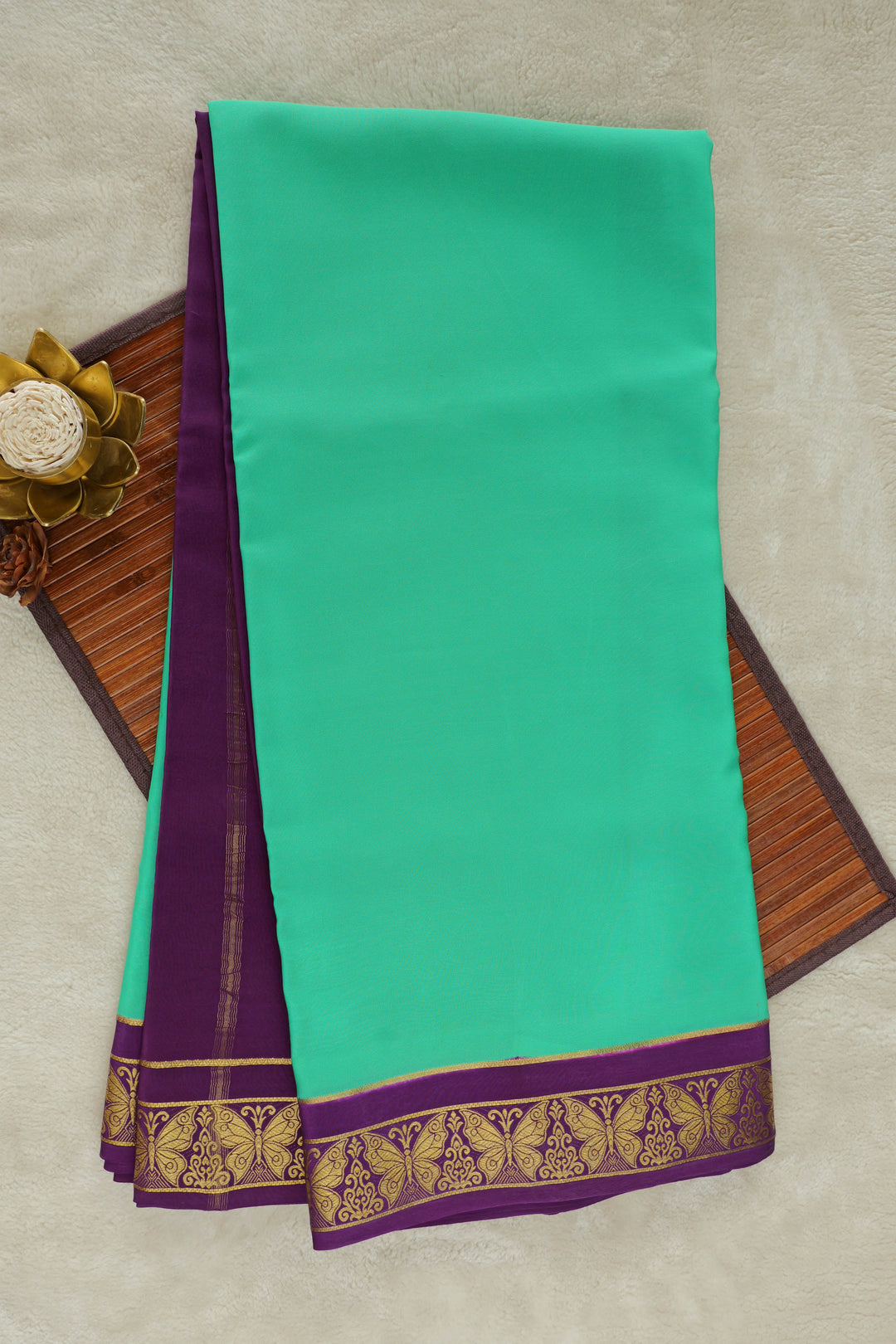 Mysore silk saree with bright green body and golden zari detailing