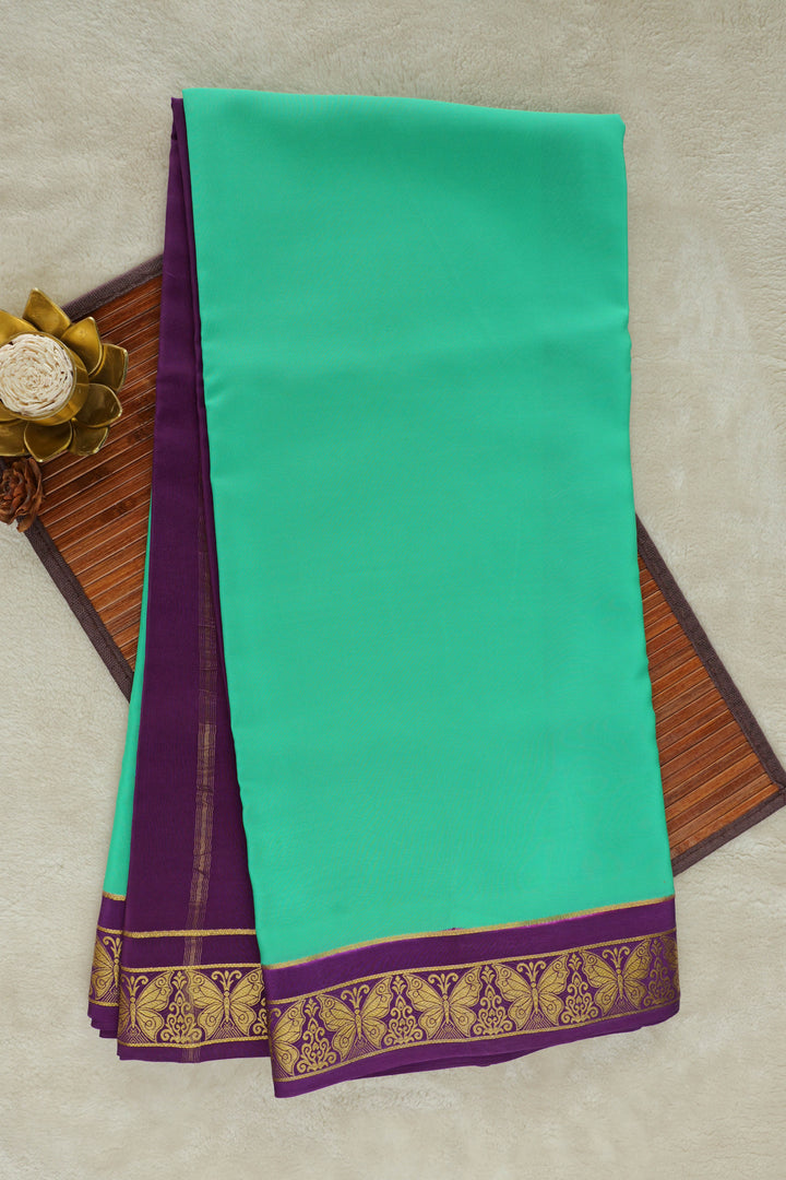 Mysore silk saree with bright green body and golden zari detailing