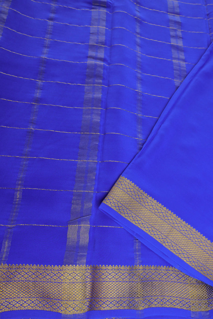 Mysore silk saree with green body, blue pallu, and zari blouse piece