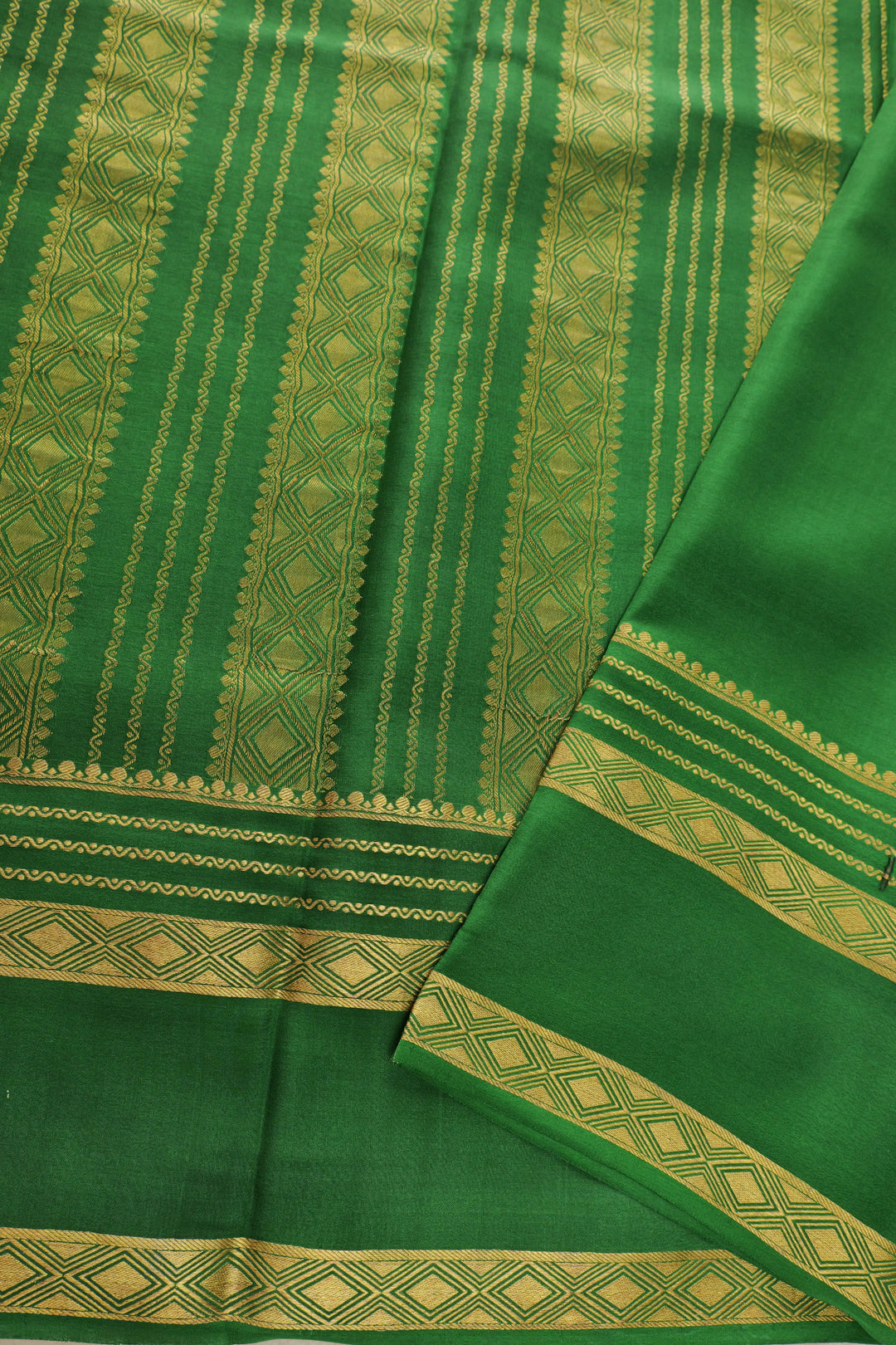 Mysore silk saree with pink base and gold-bordered green pallu