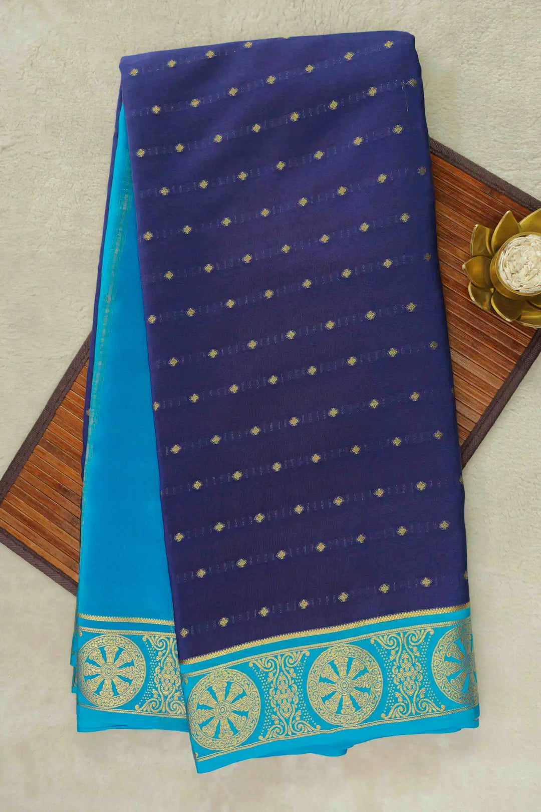 Navy blue Mysore Silk Saree with small gold buttas and sky blue pallu bordered in gold