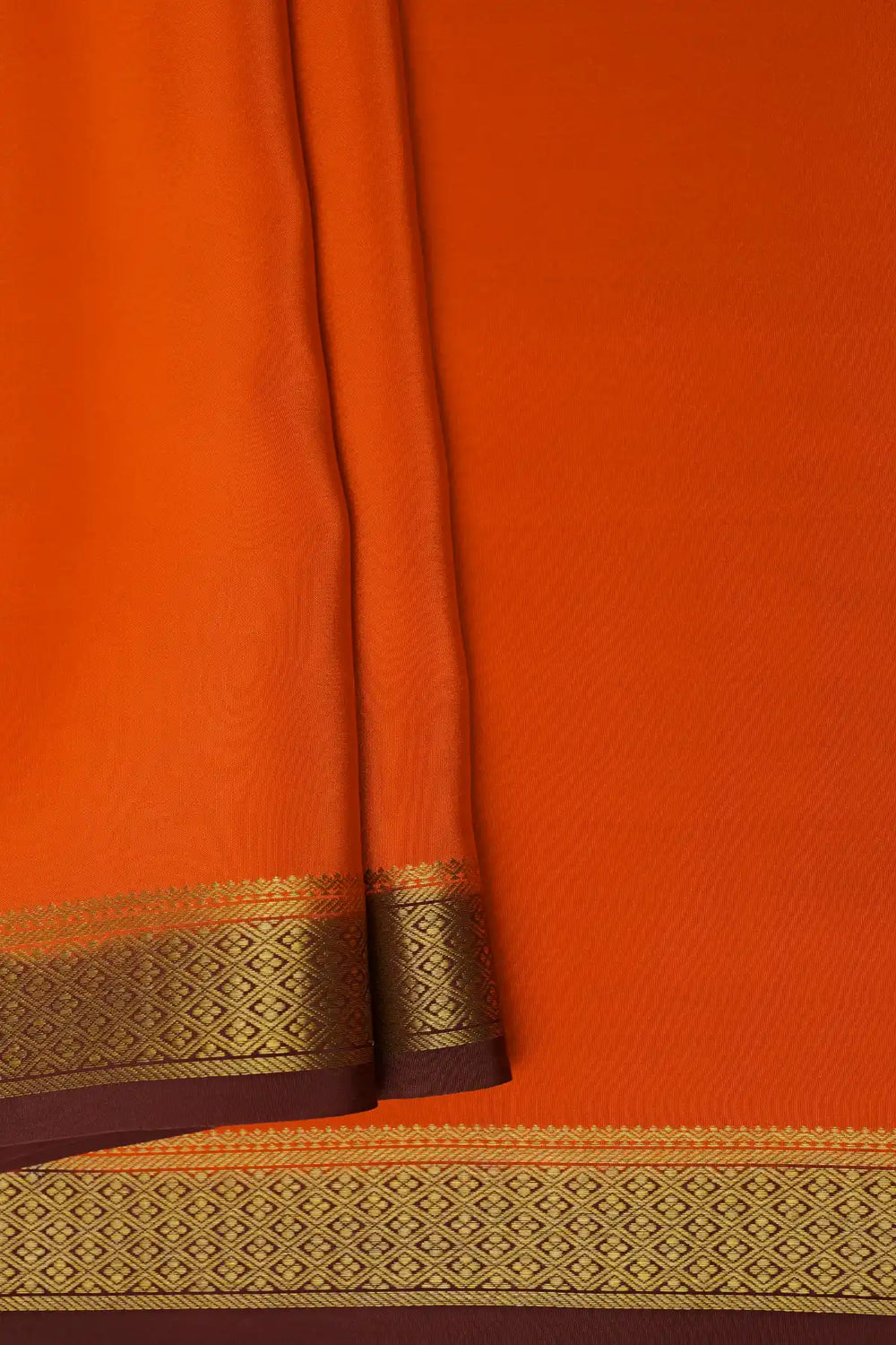 Orange Mysore silk saree with brown pallu and gold zari border