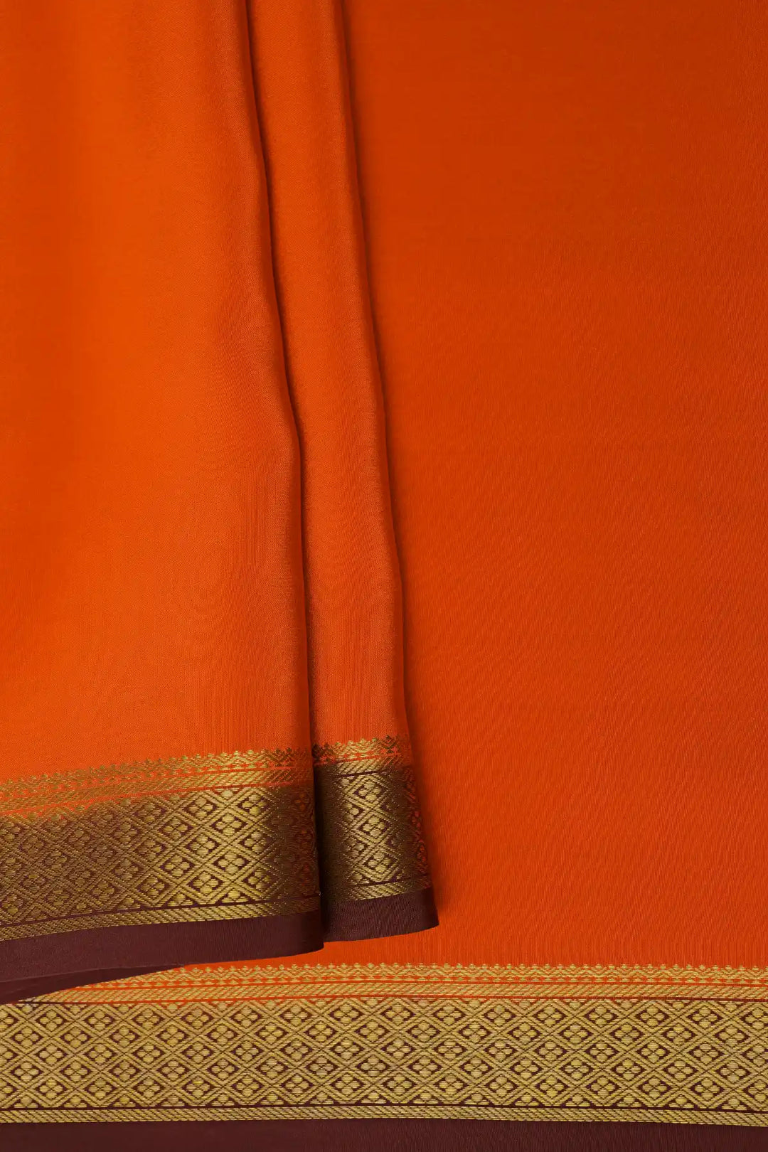 Orange Mysore silk saree with brown pallu and gold zari border