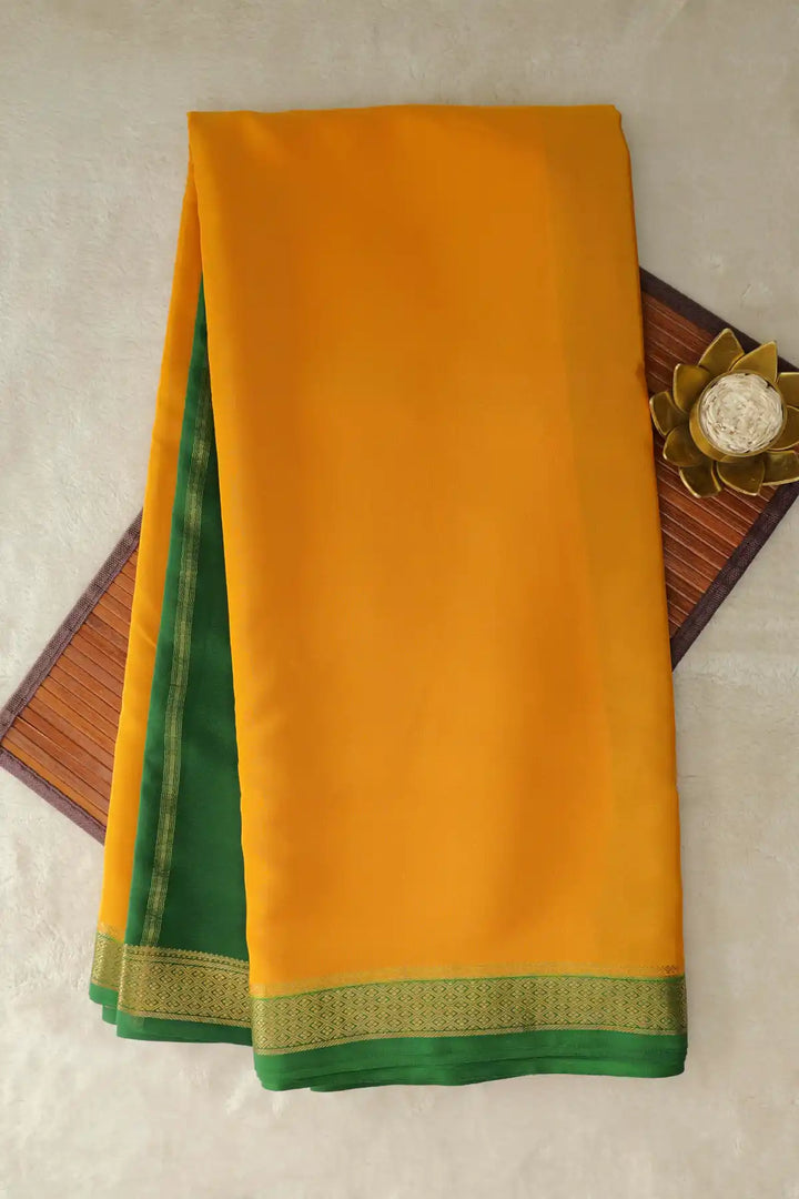Orange Mysore silk saree with green border and gold zari