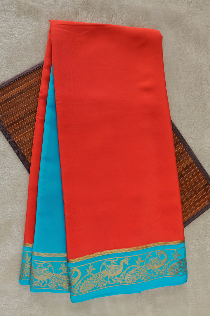 Pure Mysore silk saree in bright red with a contrasting turquoise blue and gold zari border