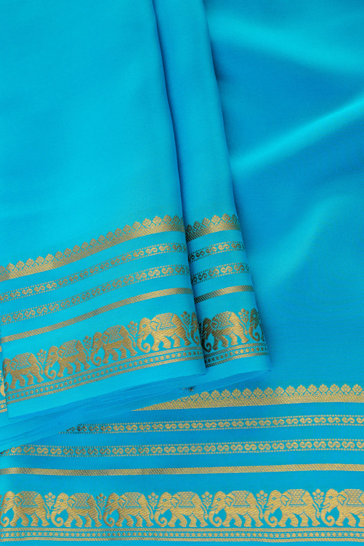 Pure turquoise blue Mysore silk saree featuring gold elephant border