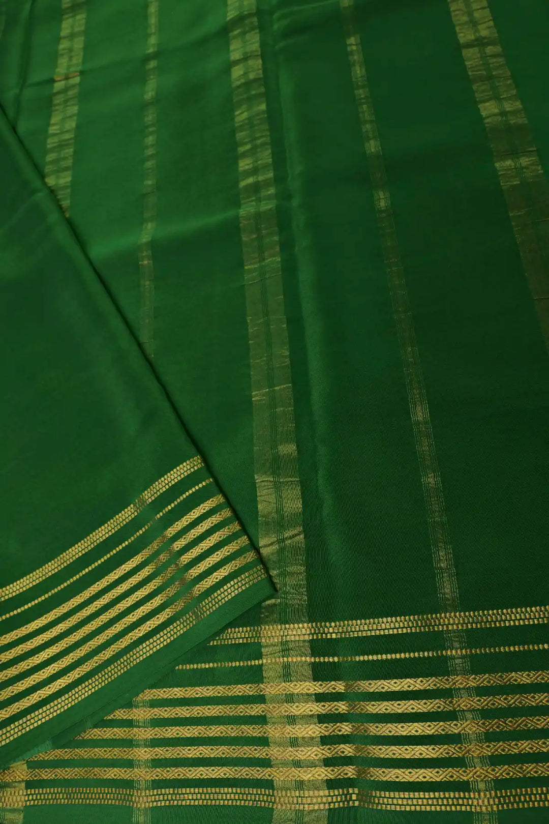 Red saree with green striped border and blouse