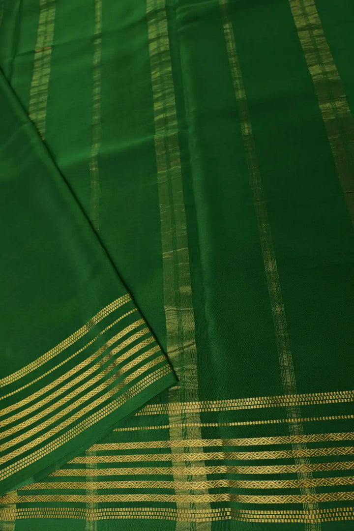 Red saree with green striped border and blouse