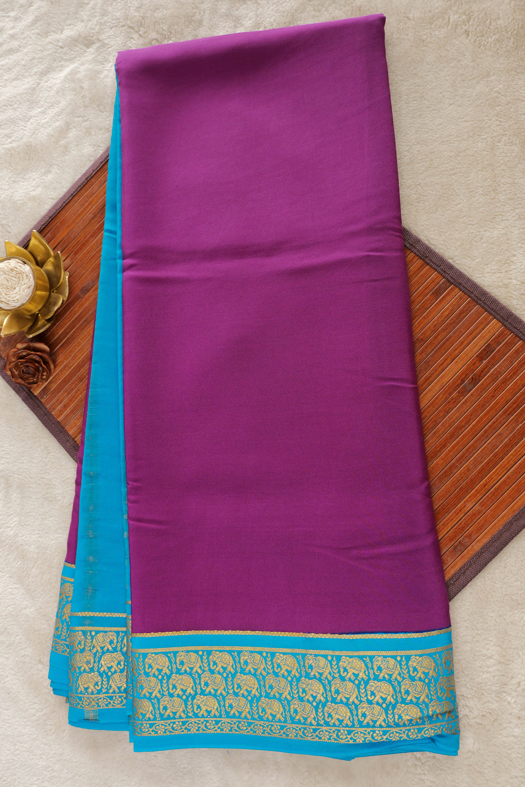 Rich purple Mysore silk saree with turquoise blue border and gold elephant motifs
