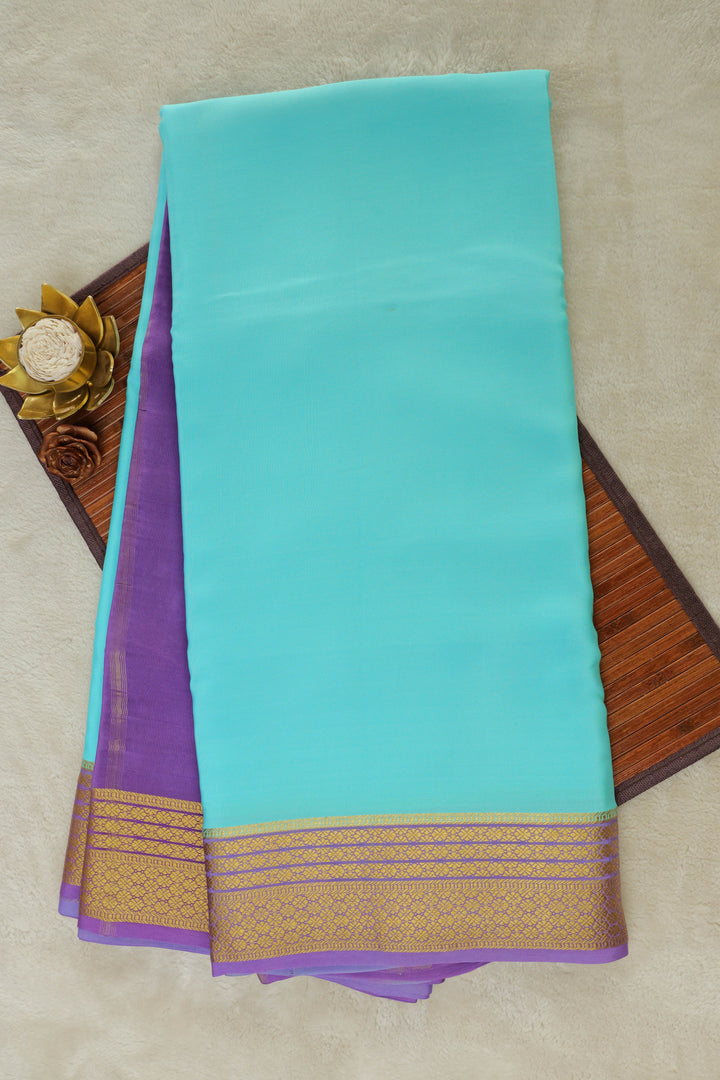 Turquoise Mysore silk saree with purple border and gold zari design