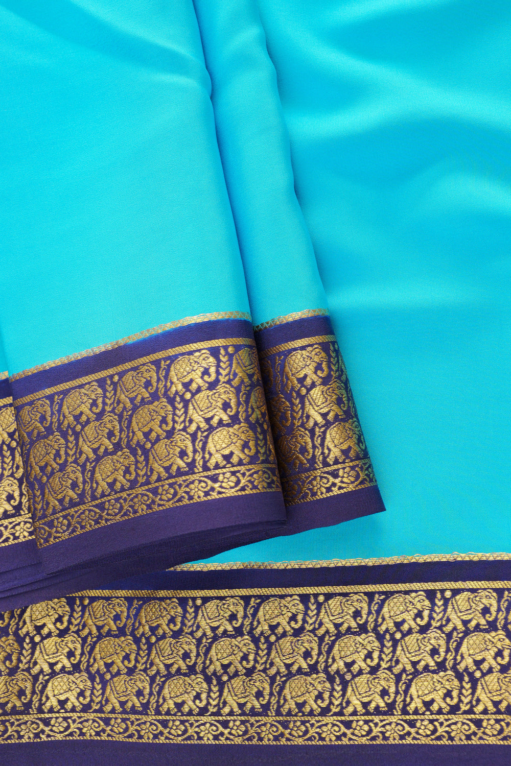 Turquoise blue Mysore silk saree with golden zari border and elephant motifs