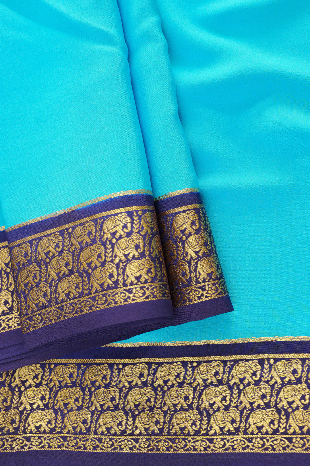 Turquoise blue Mysore silk saree with golden zari border and elephant motifs