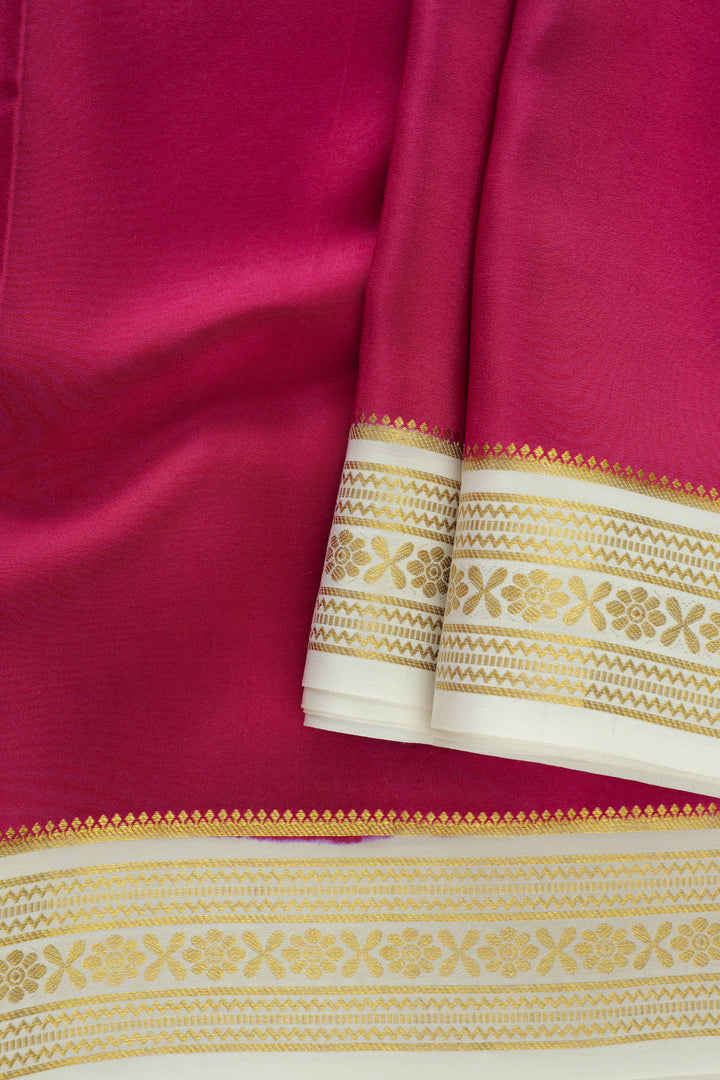 Vibrant pink Mysore silk saree with golden woven border