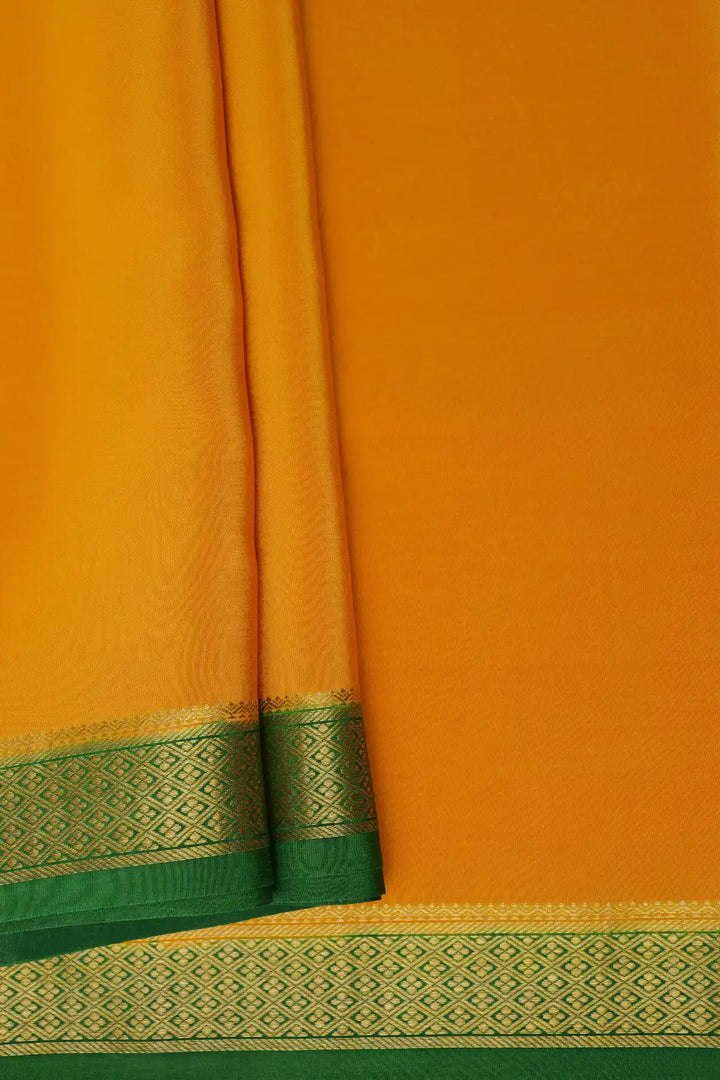 Yellow orange Mysore saree with green gold border