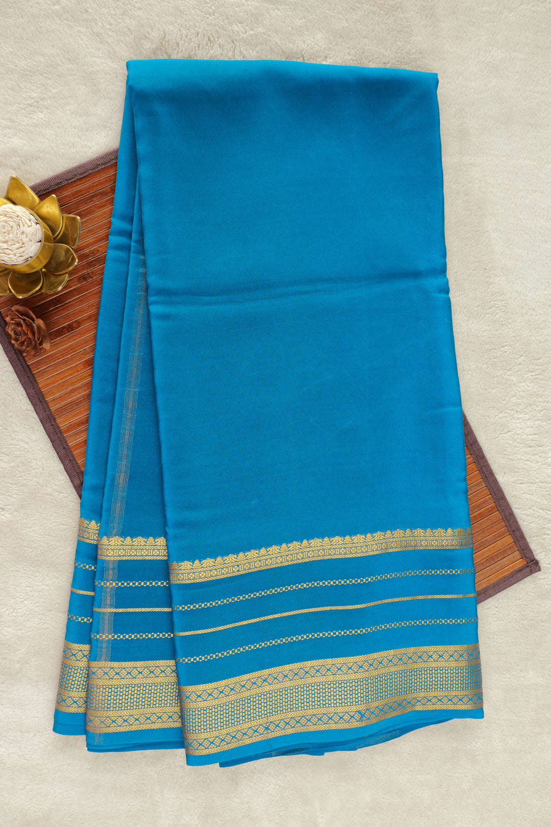  blue Mysore silk saree with a gold border.