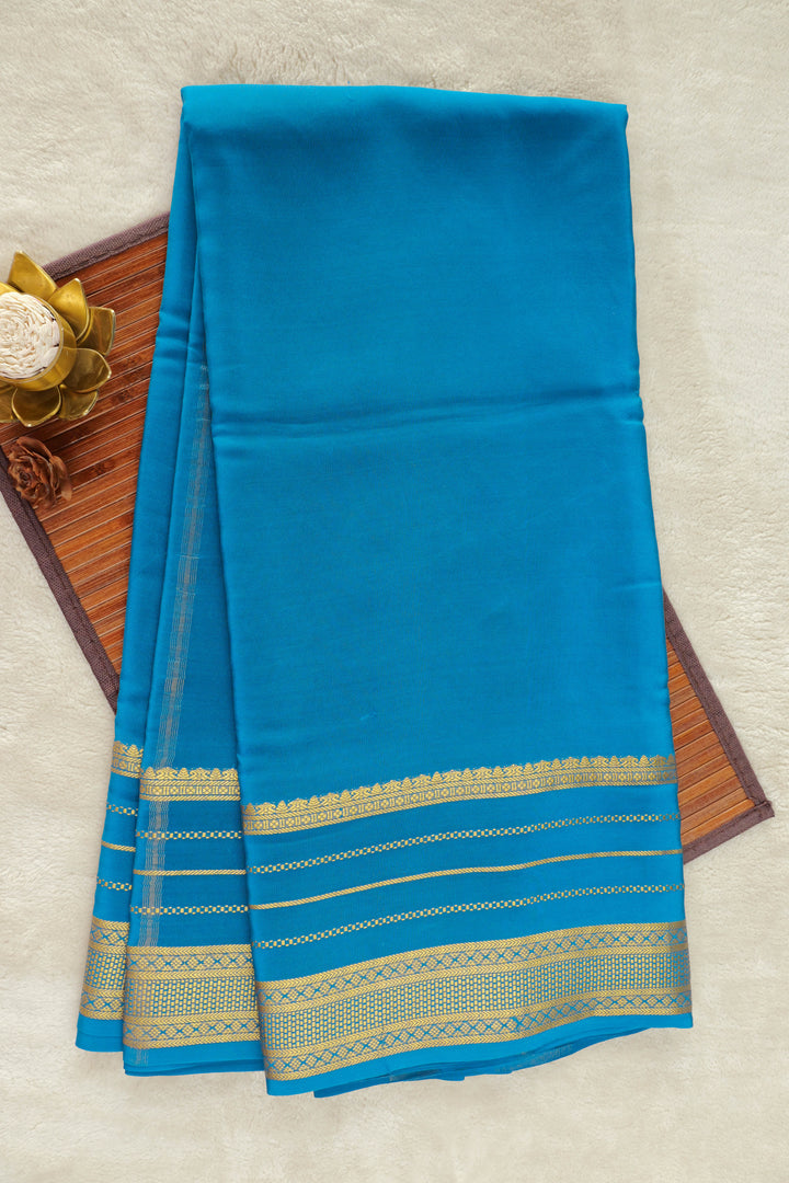  blue Mysore silk saree with a gold border.