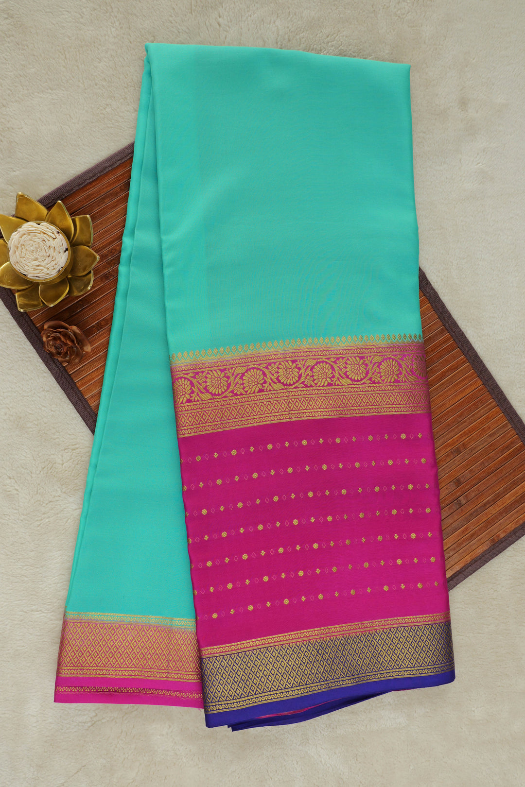 teal Mysore silk saree with a bold magenta pink pallu and gold zari border