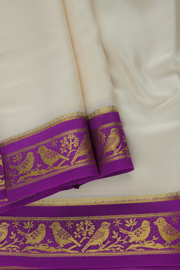white and purple silk saree with ornate golden motifs on the border